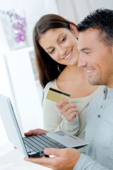 happy couple buying on line with a credit card