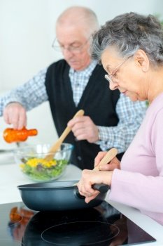 elderly couple preparing the meal
