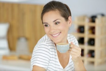 a happy woman drinking coffee