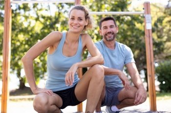 smiling couple at workout session in a park