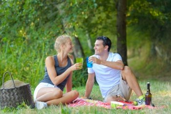 cute young couple toasting in nature
