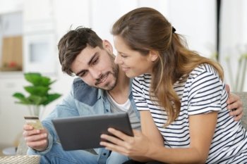 young couple shopping on internet with tablet