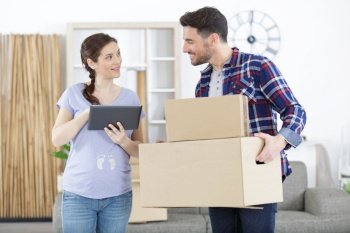 expecting couple moving boxes indoors