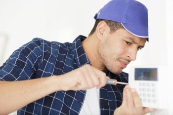 man fixing a wall device