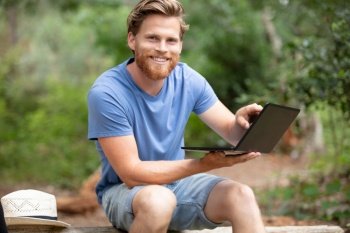 a man using pc outdoors