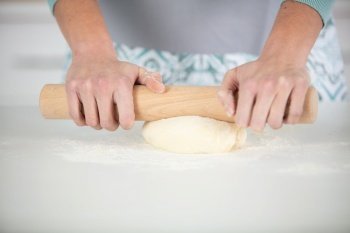 cook rolling dough with rolling-pin