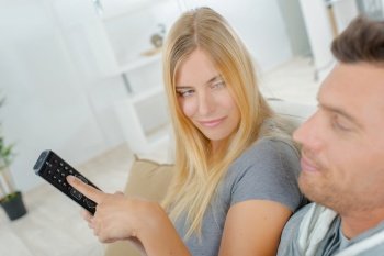 a couple holding remote control