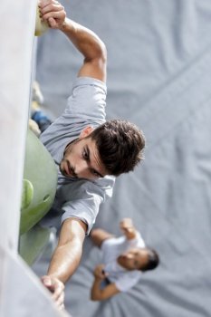 high angle view of man on indoor climbing wall