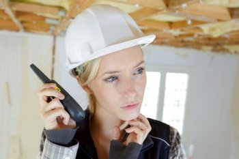 woman with a walkie-talkie in a construction site
