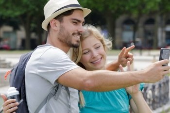 happy young tourists taking selfie outdoors