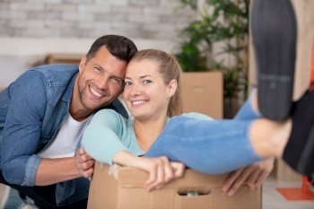 happy couple is having fun with cardboard boxes