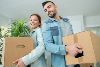 portrait of woman and man moving boxes