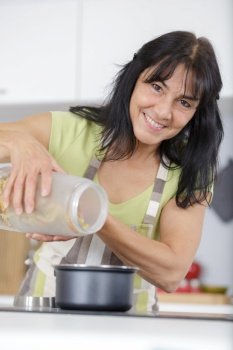 woman preparing pasta at home