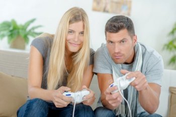 Couple at home playing computer game