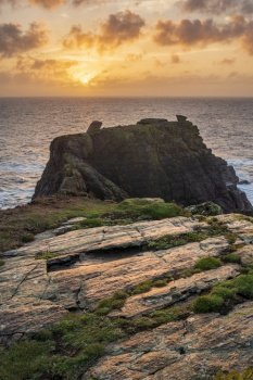 Beautiful dramatic Summer sunrise over Lizard Point in Cornwall UK with lovely glowing sky and clouds