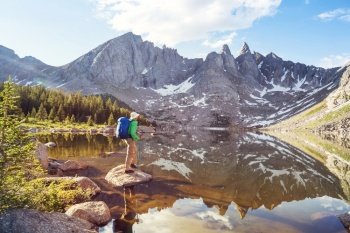 hiker in mountains on beautiful rock background