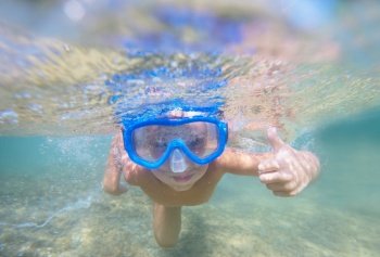 a boy underwater snorkeling in the ocean