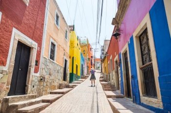 Tourist on colorful street in the famous city of Guanajuato, Mexico
