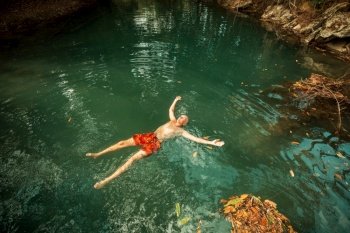 Man swimming in the tropical river