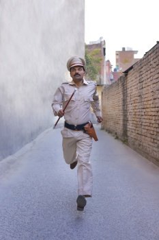 Indian policeman running while on duty