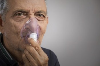 Portrait of a senior man wearing an oxygen mask.(Health and Fitness) 