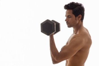 Man working out with dumbbells over a white background. 