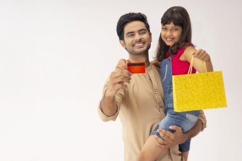 A HAPPY MAN AND DAUGHTER POSING IN FRONT OF CAMERA AFTER SHOPPING
