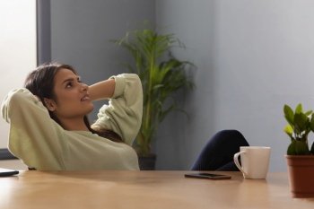 Woman relaxing at home after having coffee