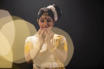 Mohiniattam dancer depicting a budding flower through her dance performance