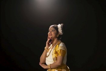 Mohiniattam dancer gazing at the sky in her dance performance