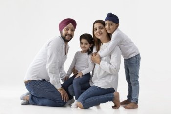 A HAPPY SIKH FAMILY POSING TOGETHER
