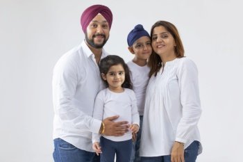 A SIKH FAMILY HAPPILY POSING TOGETHER