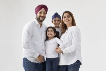A SIKH FAMILY POSING HAPPILY