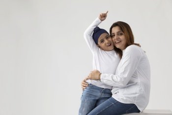A SIKH MOTHER AND SON HAPPILY PLAYING AND SPENDING TIME TOGETHER