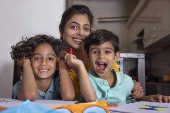 Mother with her children posing in front of camera during painting 