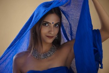Portrait of a beautiful Indian woman in blue headscarf
