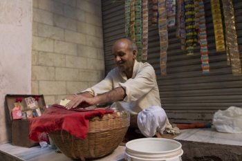 Portrait of an old aged panwala and his shop