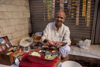 Portrait of an old aged panwala and his shop