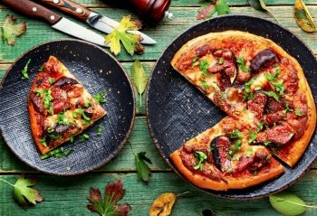 Appetizing pizza or flatbread with bacon and autumn fruit, figs.. Autumn fruit figs pizza