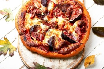Appetizing pizza with bacon and autumn fruit, figs.. Autumn fruit figs pizza or flatbread.
