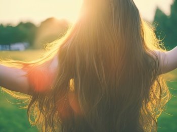 A young girl with long, flowing hair stands with open arms in a park, embracing the warm glow of the setting sun. She is surrounded by lush greenery and the golden light of the sunset casts a warm and peaceful aura over the scene. The girl’s open arms and peaceful expression suggest a sense of gratitude and joy. Her hair is billowing in the gentle breeze, adding to the feeling of freedom and beauty. The image captures a fleeting moment of peace and contentment in the midst of a bustling world. It invites the viewer to pause and appreciate the simple pleasures in life. AI generative illustration