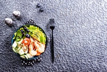 salad with avocado and shrimps in bowl, selective focus