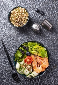 salad with avocado and shrimps in bowl, selective focus