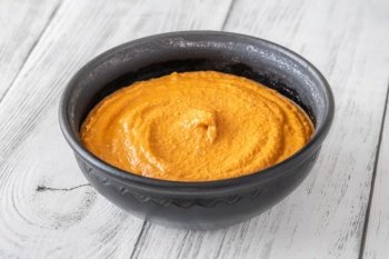 Bowl of classic Muhammara spicy dip made of walnuts, red bell peppers