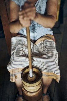 Woman making butter with butter churn. Old traditional method making of butter