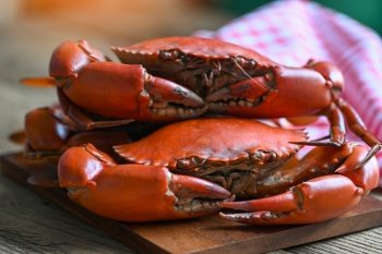 fresh crab on wooden cutting board, seafood crab cooking food boiled or steamed crab red in the seafood restaurant kitchen