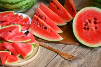 Watermelon slice and cut half on wooden background, Closeup sweet watermelon slices pieces fresh watermelon tropical summer fruit