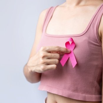 Pink October Breast Cancer Awareness month, woman hand hold pink Ribbon and wear shirt for support people life and illness. National cancer survivors month, Mother and World cancer day concept