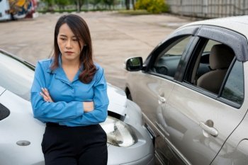 Women drivers sad after a car accident because not have car accident insurance.