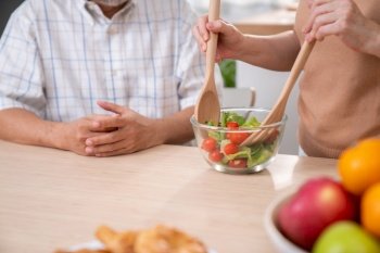 Contented senior couples who are happy to cook together with bread veggies and fruit in their kitchen.. Contented senior couples who are happy to cook together.